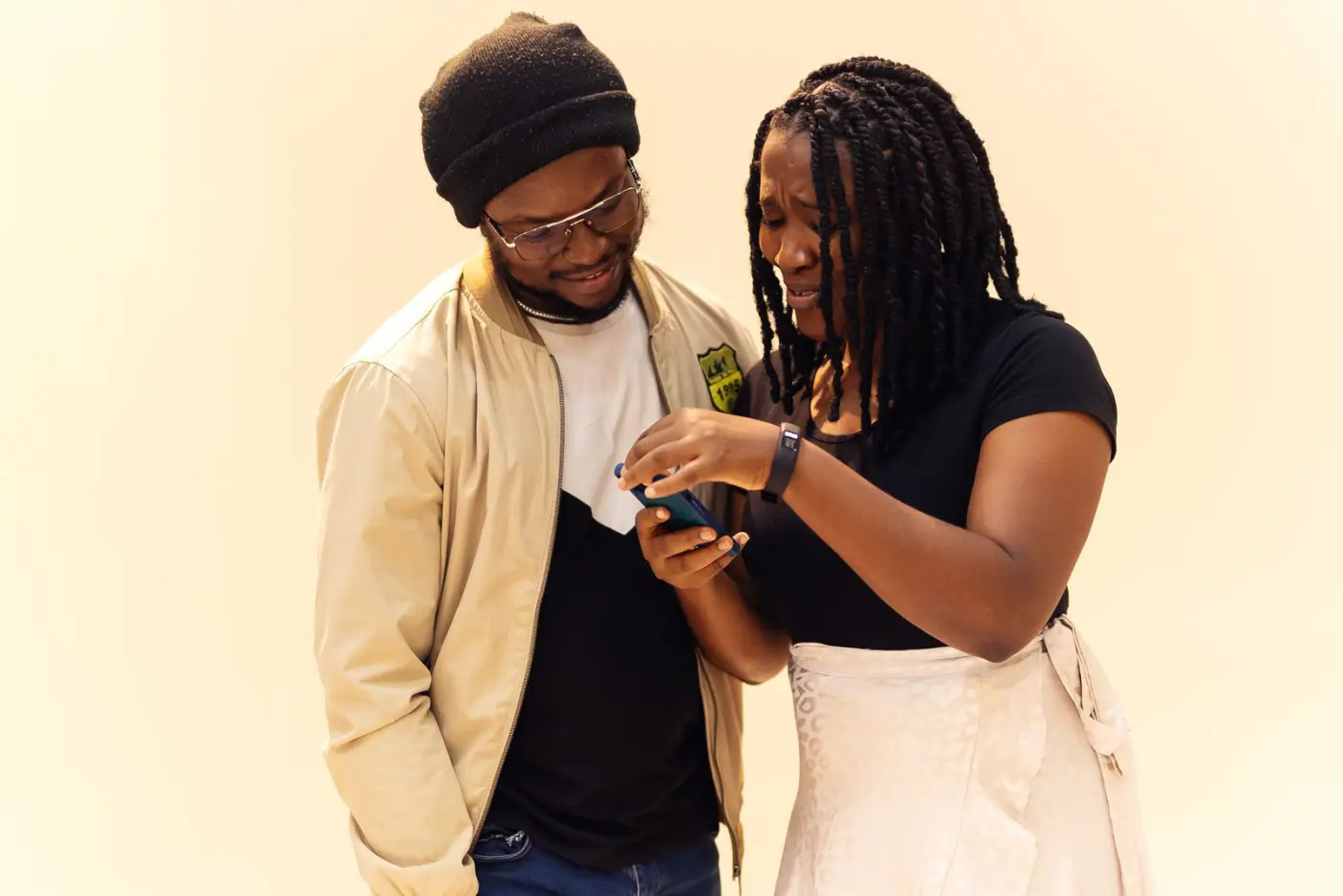 Two friends looking at a phone together in Lagos