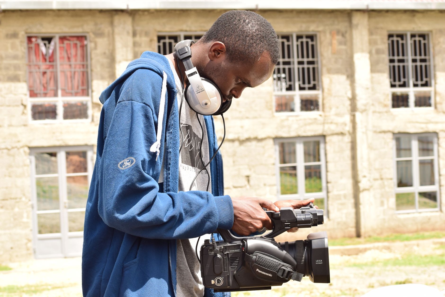 Creator filming outdoors with a video camera.